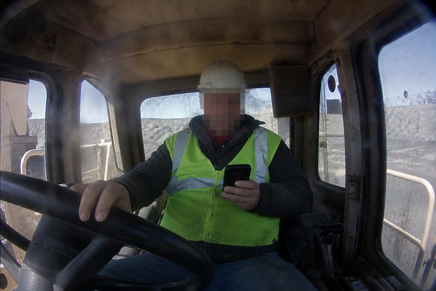 Heavy equipment operator at work in the cab — Tango monitors operator behavior and distraction in real time to prevent incidents